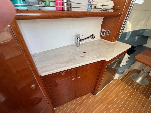 Slide: The Image of 2016 Intrepid 475 Panacea yacht interior with wooden cabinetry and marble countertop. - 38
