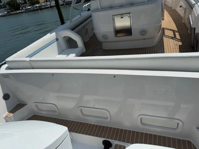 Slide: The Image of 2016 Intrepid Panacea boat interior with sleek white design and wooden flooring. - 4