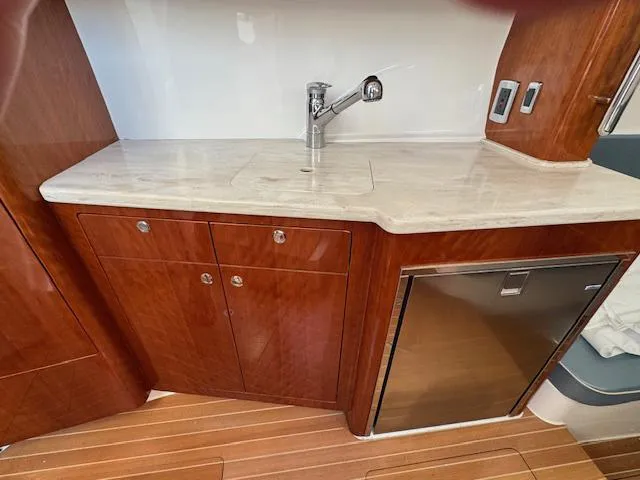 Slide: The Image of 2016 Intrepid 475 Panacea yacht interior with wooden cabinetry and stainless steel fixtures. - 40