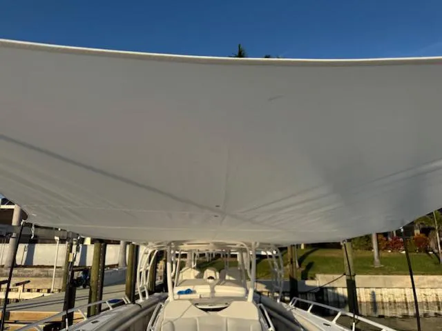 Slide: The Image of 2016 Intrepid 475 Panacea boat with sunshade, docked under clear blue sky. - 45