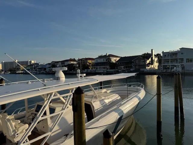 Slide: The Image of 2016 Intrepid 475 Panacea boat docked in a serene waterfront setting. - 46