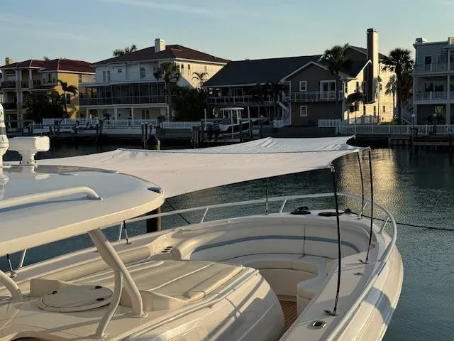 Slide: The Image of 2016 Intrepid 475 Panacea boat docked near waterfront homes at sunset. - 47