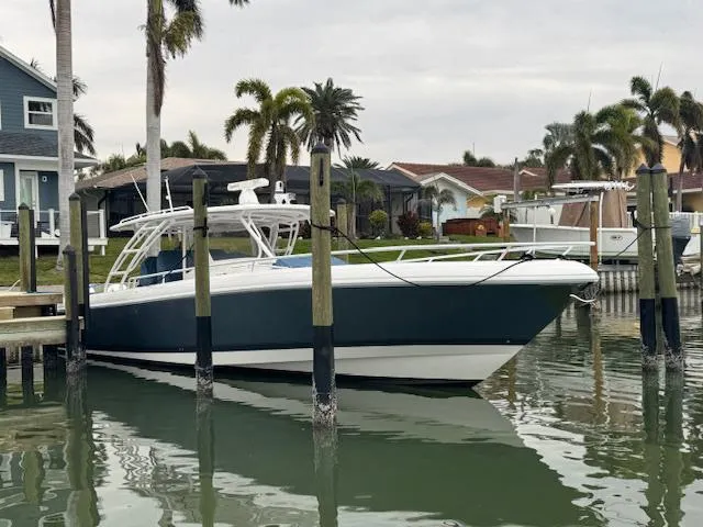 Slide: The Image of 2016 Intrepid Panacea boat docked in a scenic marina with palm trees. - 7