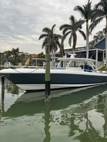 Slide: The Image of 2016 Intrepid Panacea boat docked near palm trees and waterfront homes. - 9