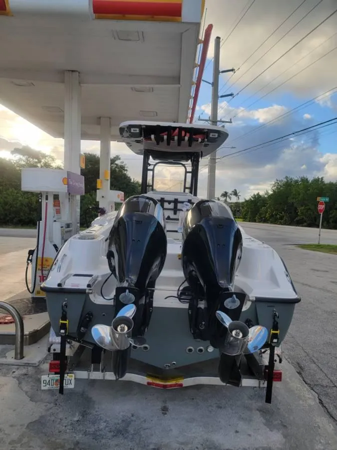 Slide: The Image of 2023 Key West 244 Center Console boat at a gas station with dual engines. - 3