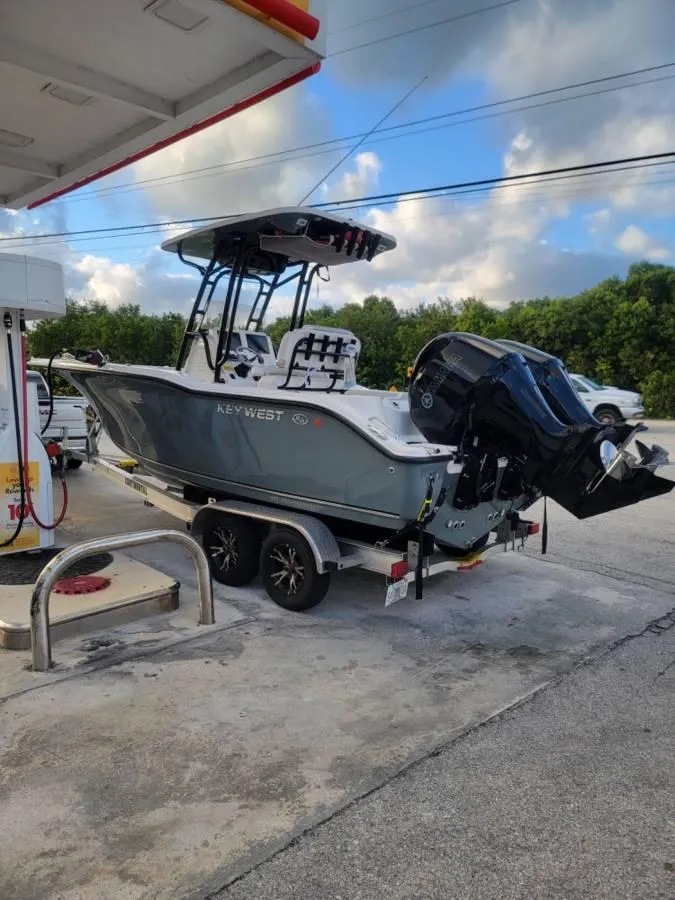 Slide: The Image of 2023 Key West 244 Center Console boat at a gas station, on a trailer. - 4