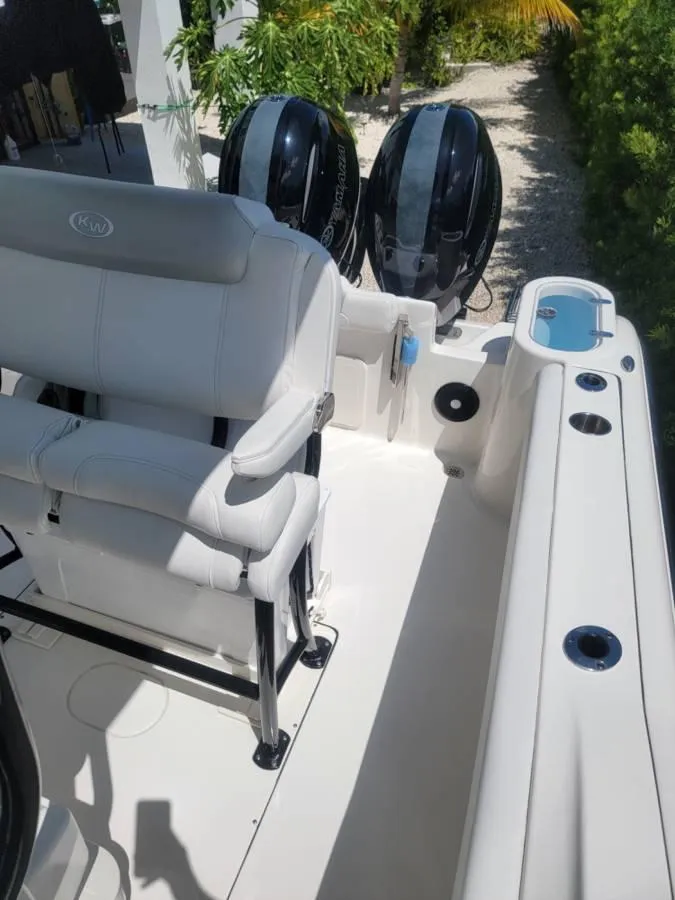 Slide: The Image of 2023 Key West 244 Center Console boat interior with dual engines and seating. - 5