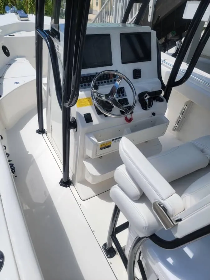 Slide: The Image of 2023 Key West 244 Center Console boat interior with steering wheel and control panel. - 6