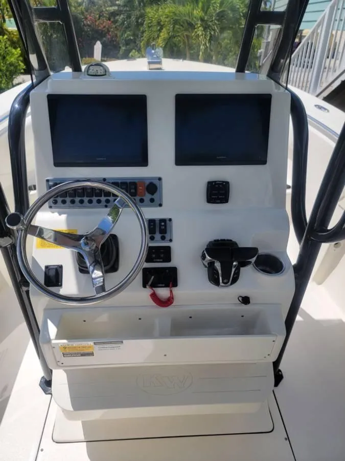 Slide: The Image of 2023 Key West 244 Center Console boat dashboard with dual screens and steering wheel. - 8