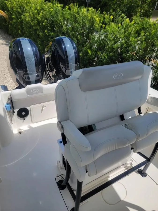 Slide: The Image of 2023 Key West 244 Center Console boat with dual engines and cushioned seating. - 9