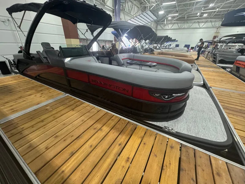 Slide: The Image of 2025 Bennington 24MFB-SPS (TC) pontoon boat displayed indoors on wooden dock. - 3