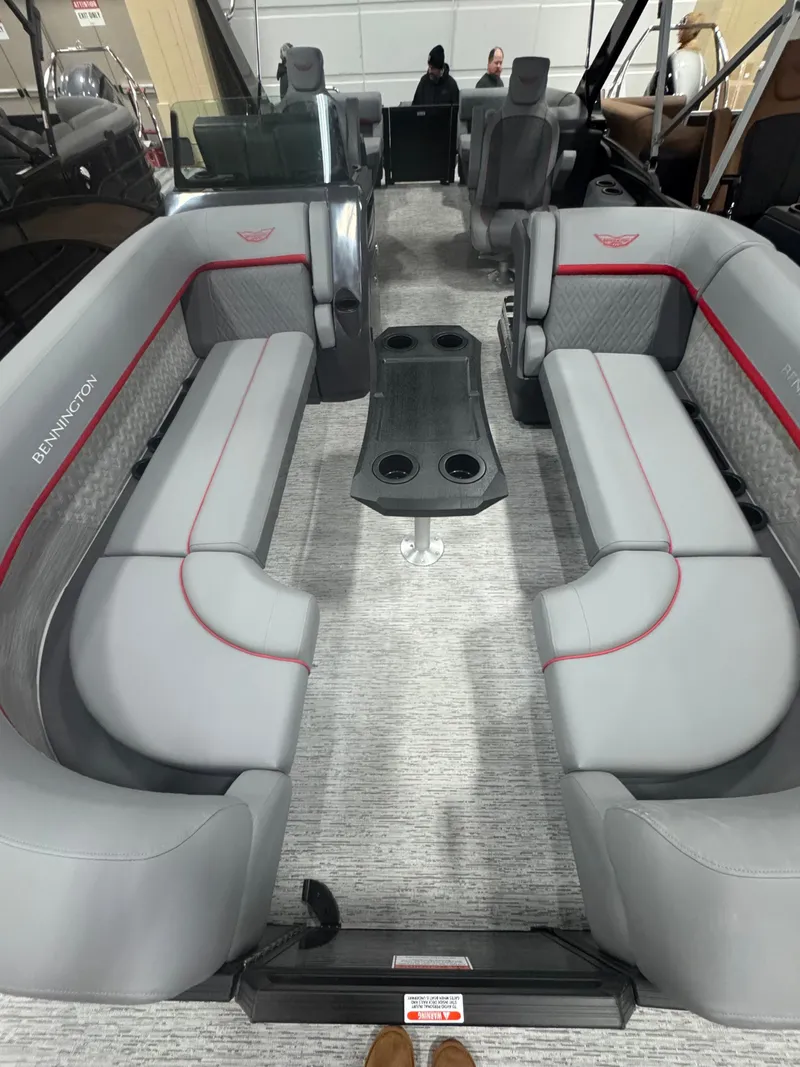 Slide: The Image of 2025 Bennington 24MFB-SPS pontoon boat interior with gray seating and central table. - 5