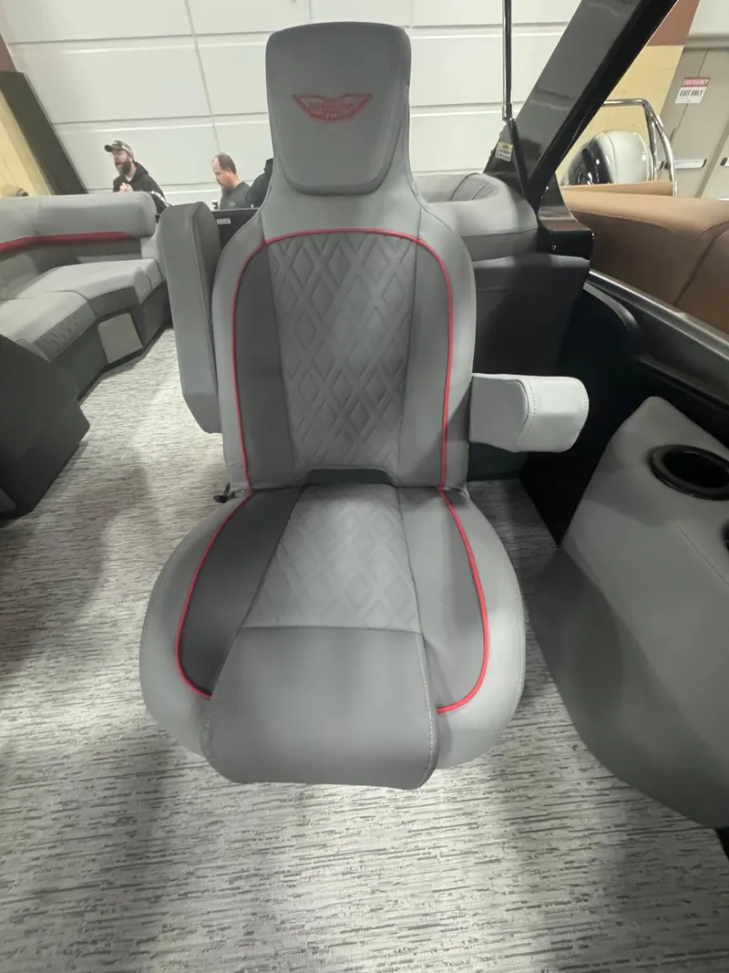Slide: The Image of 2025 Bennington 24MFB-SPS (TC) boat seat with gray upholstery and red accents. - 8