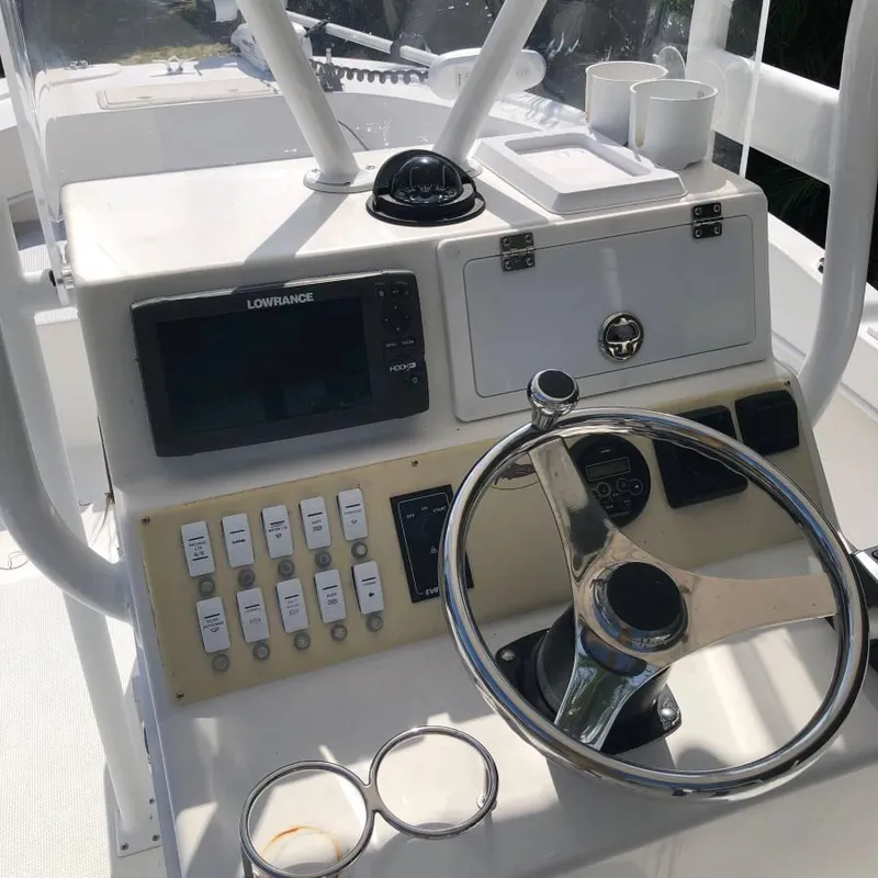 Slide: The Image of Steering console of a 2017 Dusky 227 XF boat with navigation equipment. - 4