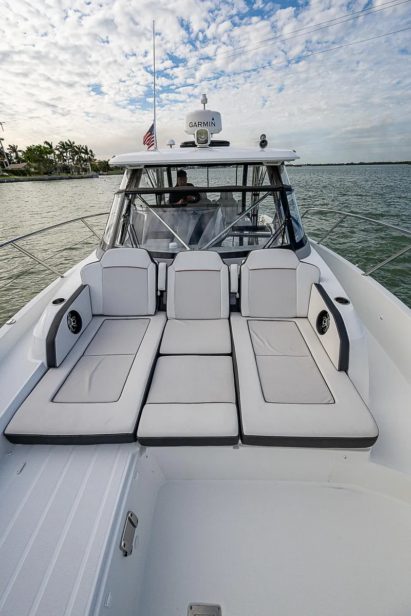 Slide: The Image of 2022 Jeanneau Leader 12.5 boat with spacious deck and seating, cruising on calm waters. - 21
