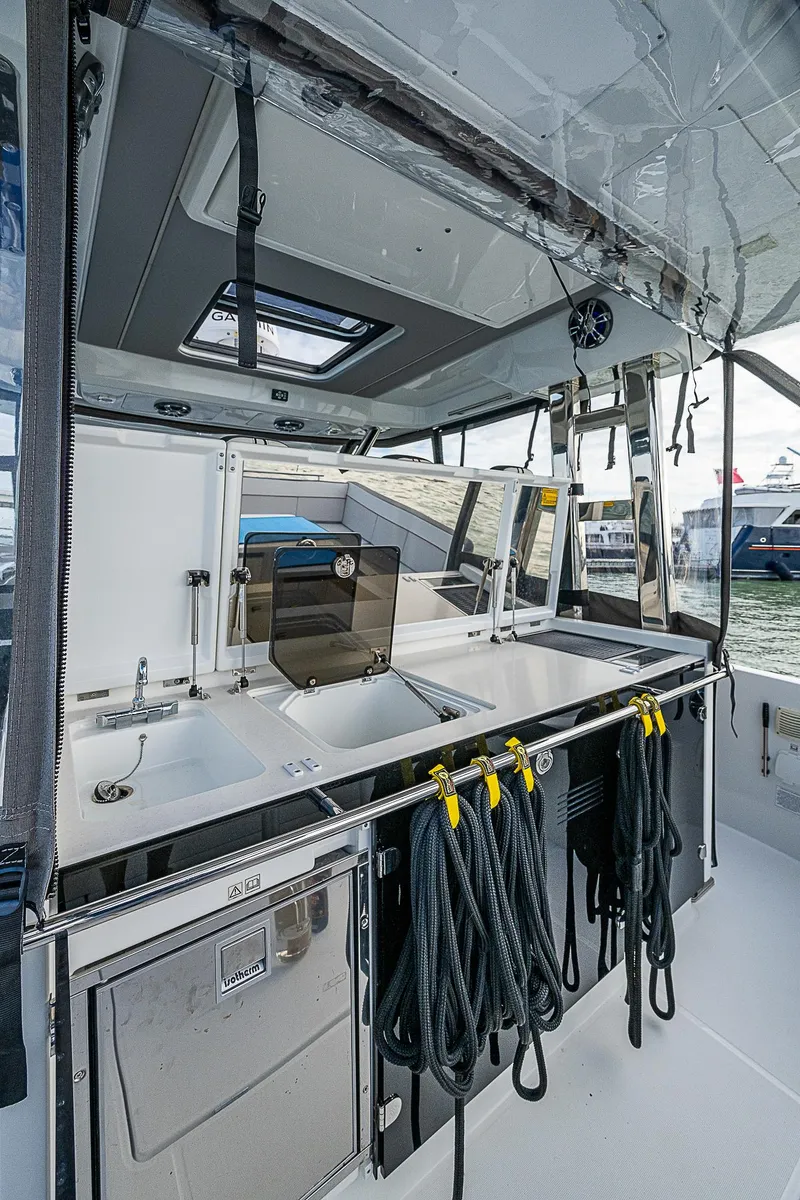 Slide: The Image of 2022 Jeanneau Leader 12.5 boat interior with modern kitchen and storage. - 25