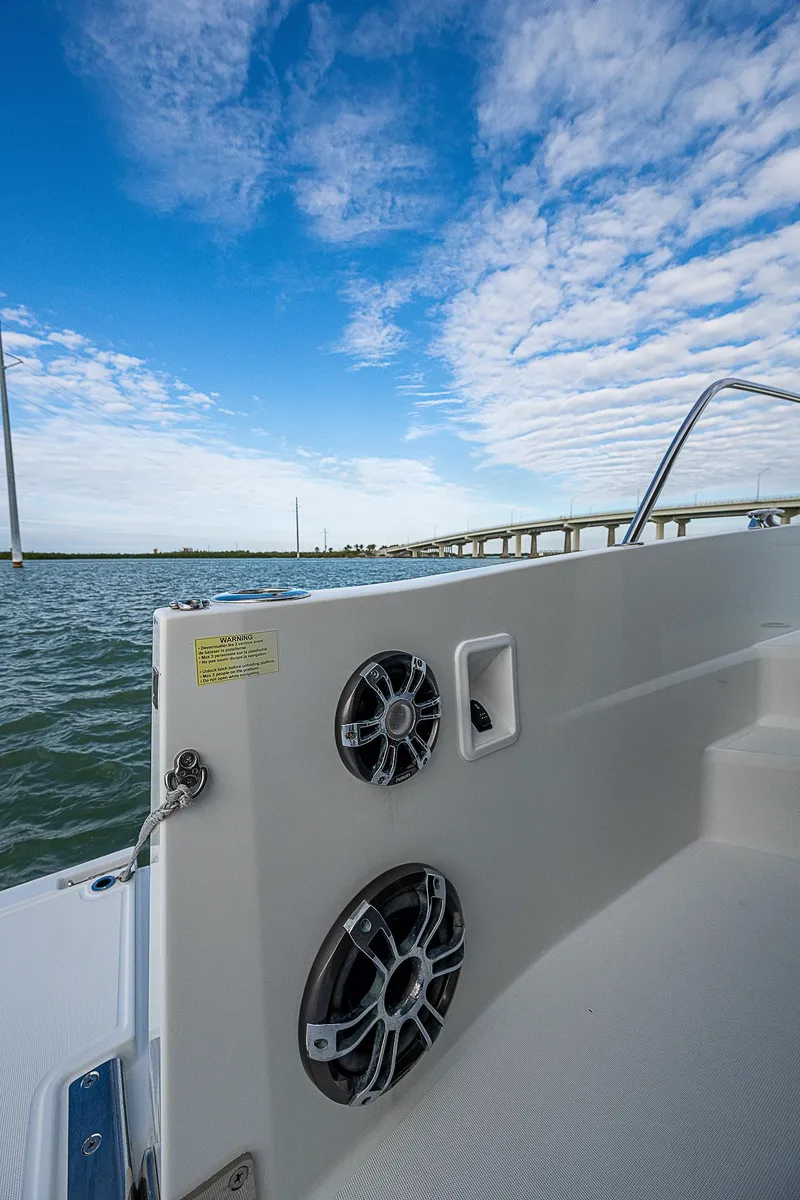 Slide: The Image of 2022 Jeanneau Leader 12.5 boat on water, showcasing speakers and clear sky. - 29