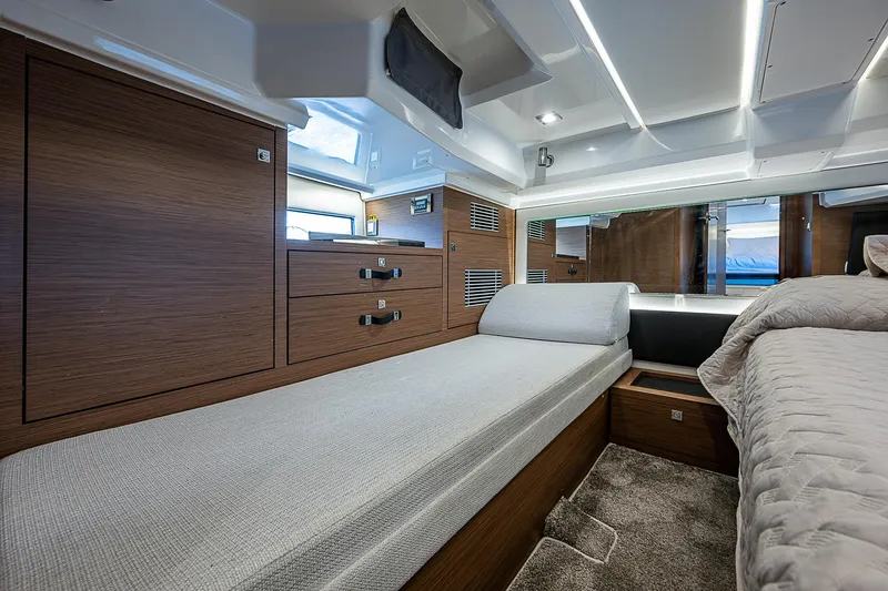 Slide: The Image of Luxurious interior of 2022 Jeanneau Leader 12.5 yacht with modern wood finish and comfortable bedding. - 38