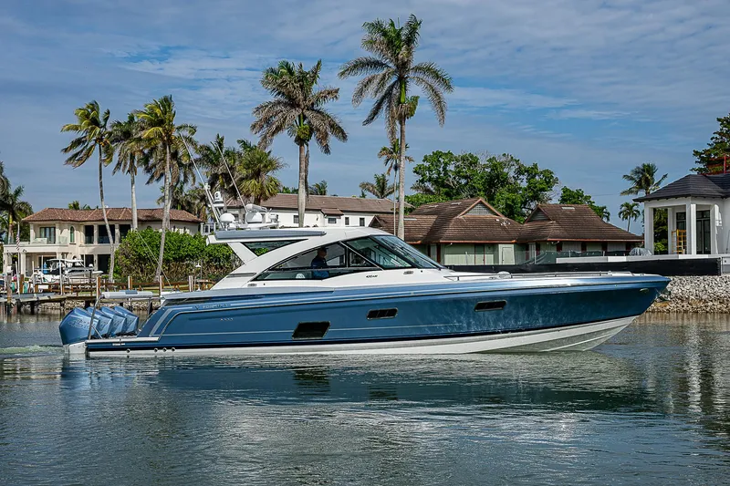 The Image of 2022 Formula 430 All Sport Crossover boat on water, surrounded by palm trees and houses. - 1