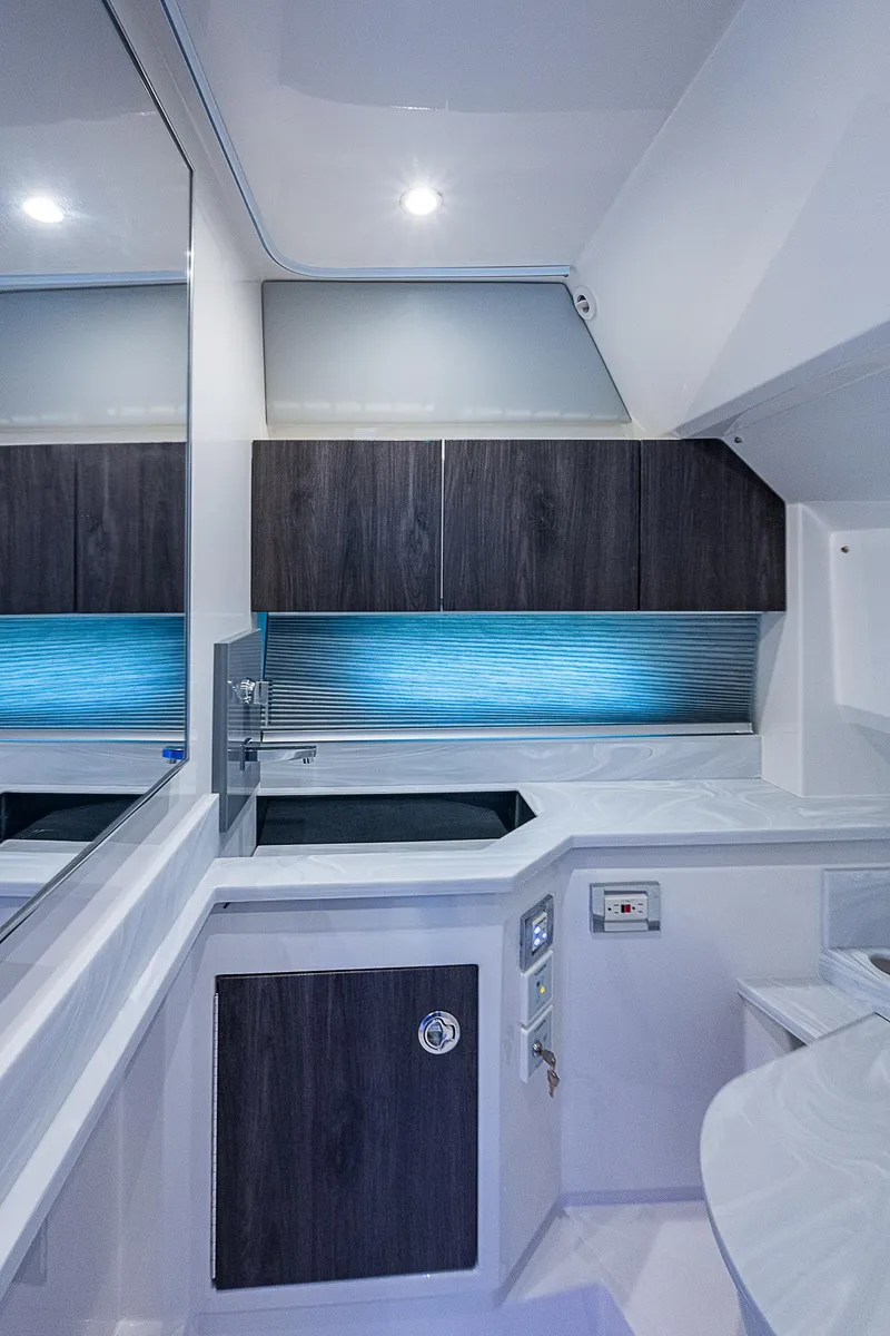 Slide: The Image of Interior of 2022 Formula 430 All Sport Crossover, featuring modern cabinetry and ambient lighting. - 12