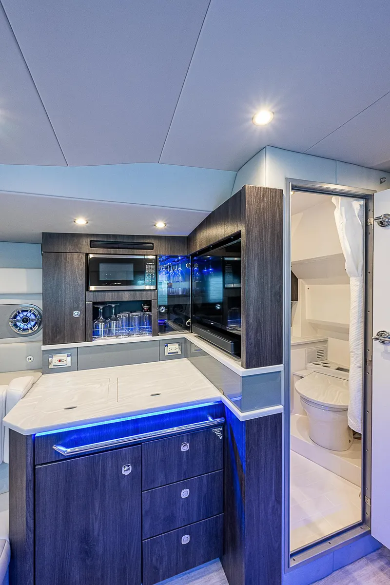 Slide: The Image of Interior of 2022 Formula 430 All Sport Crossover yacht, featuring modern kitchen and bathroom. - 14