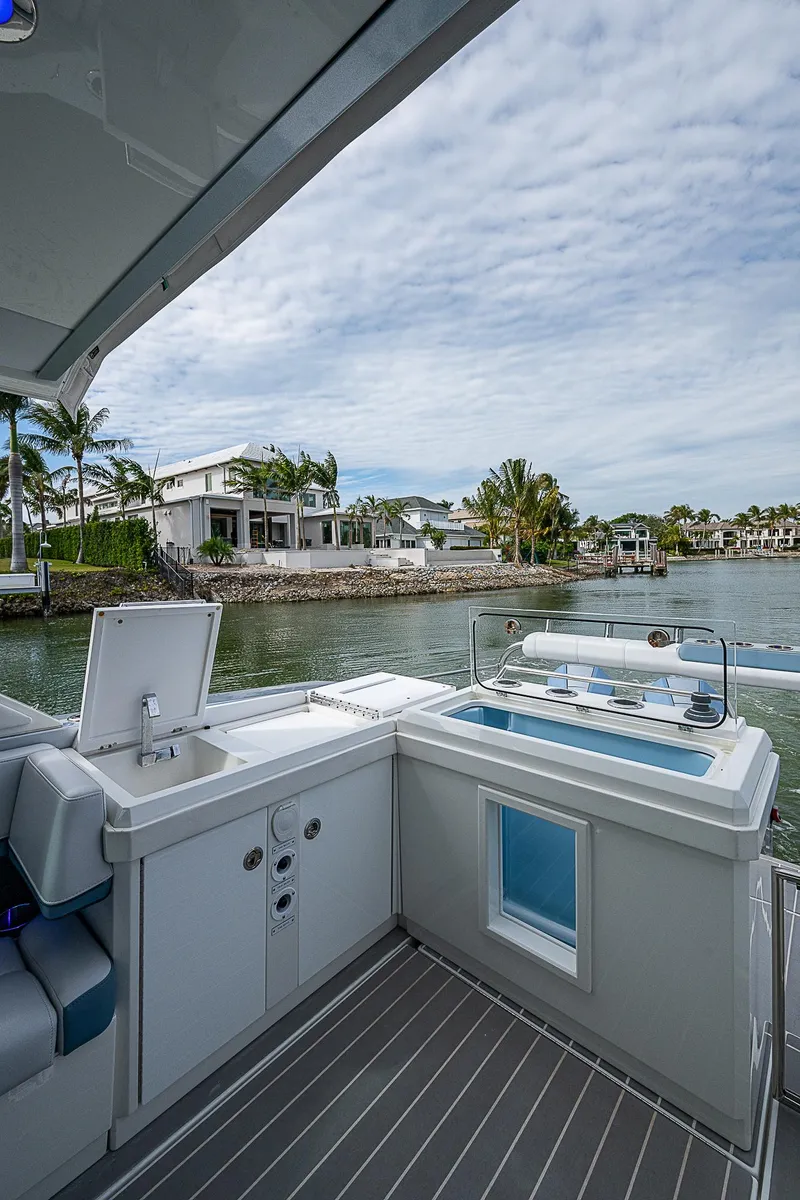 Slide: The Image of 2022 Formula 430 All Sport Crossover boat with luxurious deck and waterfront view. - 17