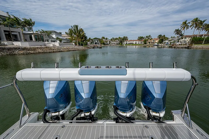 Slide: The Image of 2022 Formula 430 All Sport Crossover with four outboard engines on a scenic waterway. - 21
