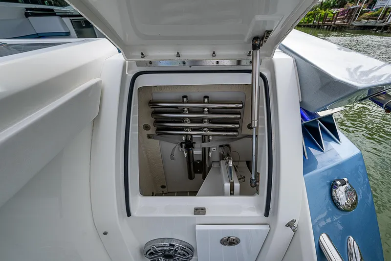 Slide: The Image of 2022 Formula 430 All Sport Crossover boat storage compartment open by the water. - 23