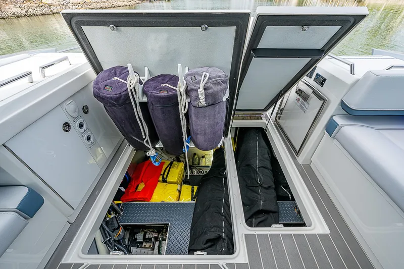 Slide: The Image of 2022 Formula 430 All Sport Crossover boat storage compartments open, showcasing interior organization. - 26