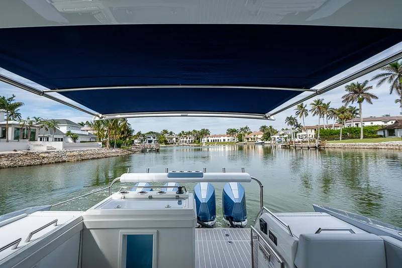 Slide: The Image of 2022 Formula 430 All Sport Crossover boat with scenic waterfront view. - 31