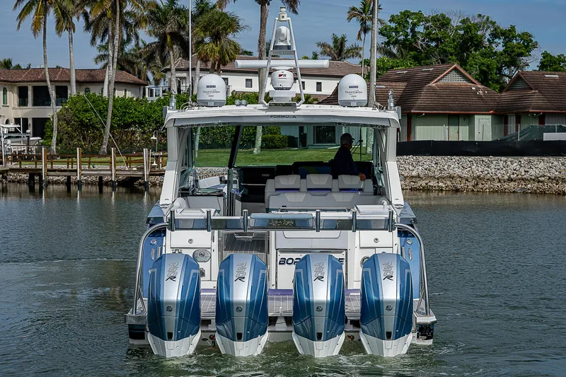 Slide: The Image of 2022 Formula 430 All Sport Crossover boat with four engines on a calm waterway. - 4