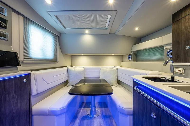 Slide: The Image of Interior of 2022 Formula 430 All Sport Crossover, featuring modern seating and ambient lighting. - 7