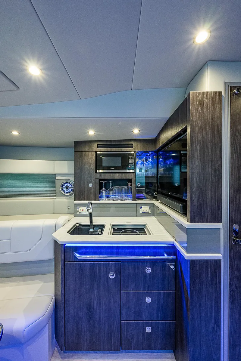 Slide: The Image of Interior of 2022 Formula 430 All Sport Crossover, featuring modern kitchen and ambient lighting. - 9