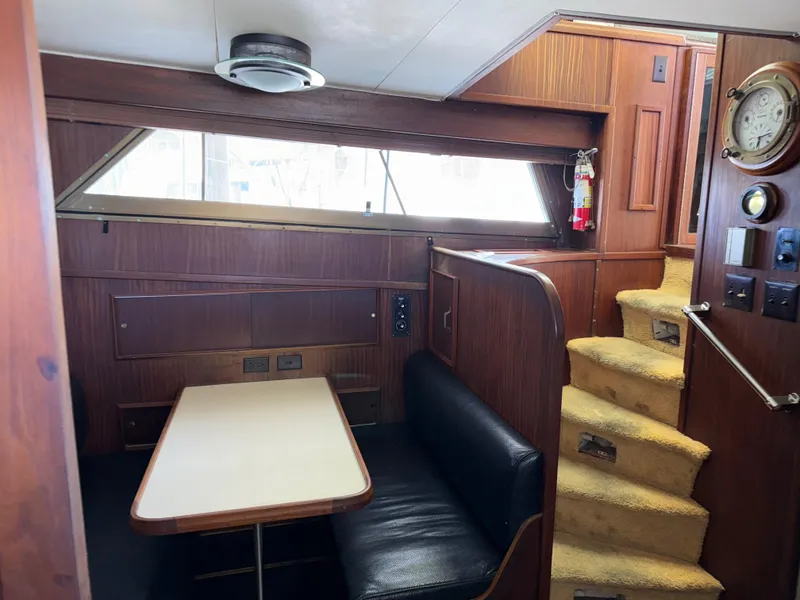 Slide: The Image of Interior of 1980 Hatteras 58MY yacht with dining area and staircase. - 11