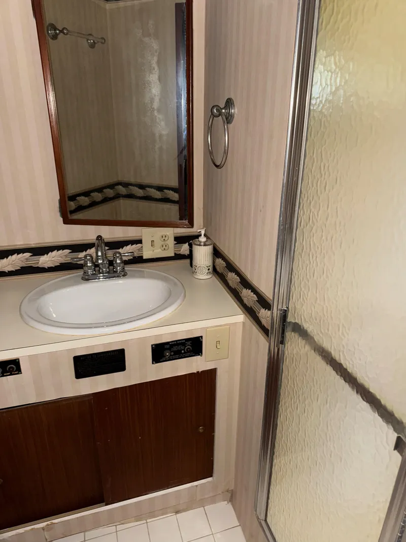 Slide: The Image of Bathroom interior of a 1980 Hatteras 58MY yacht with sink and shower. - 13