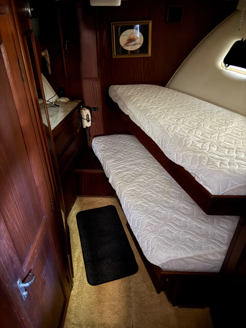 Slide: The Image of Interior cabin of 1980 Hatteras 58MY yacht with bunk beds and wooden paneling. - 14
