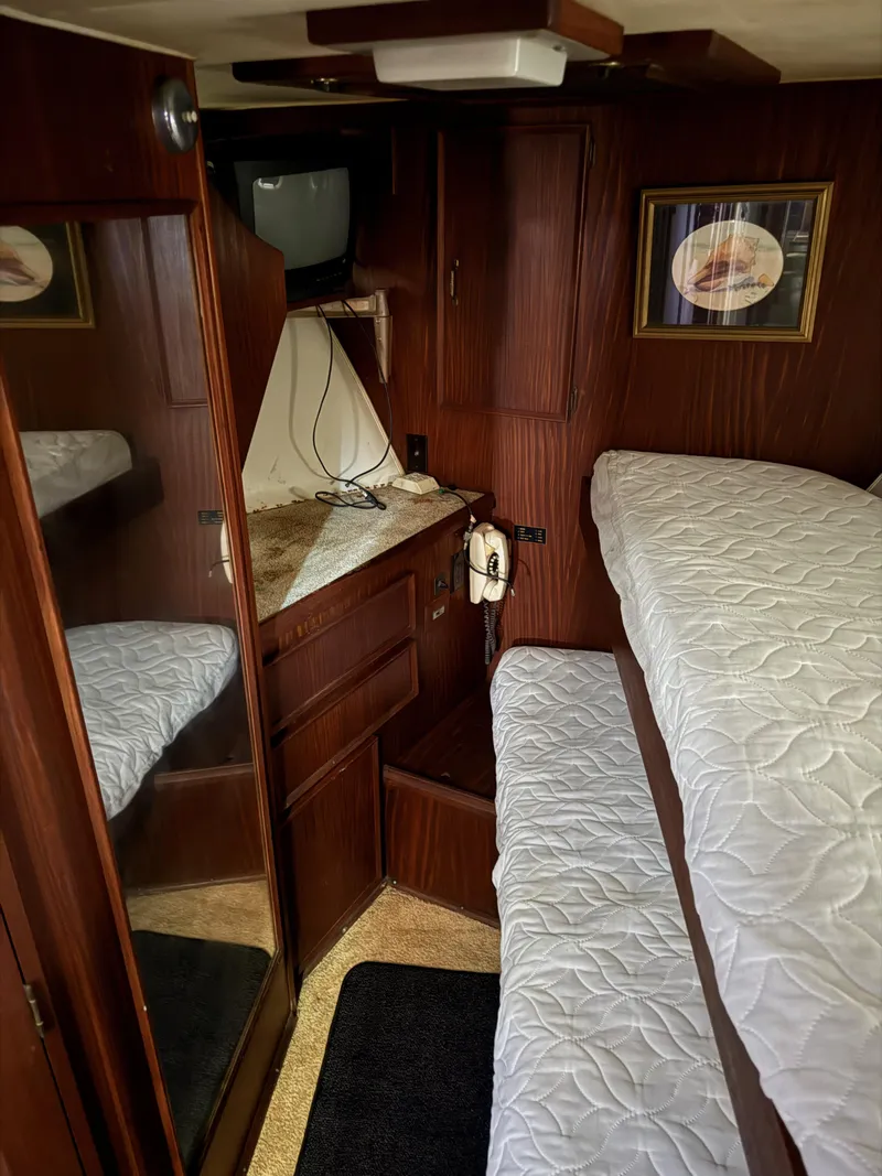 Slide: The Image of Interior of 1980 Hatteras 58MY yacht with bunk beds and wood paneling. - 15