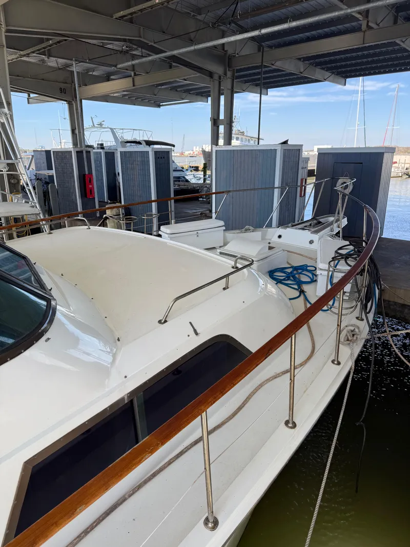 Slide: The Image of 1980 Hatteras 58MY yacht docked under a covered marina. - 2