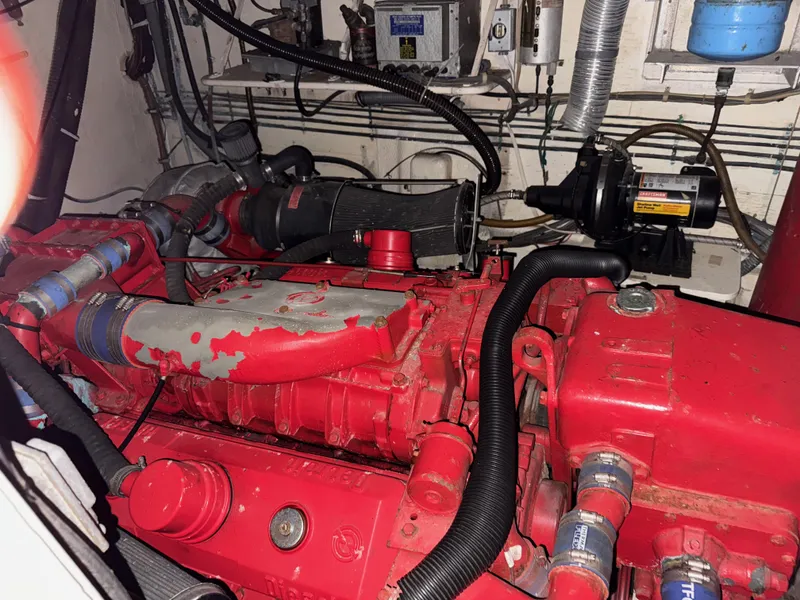 Slide: The Image of Engine room of a 1980 Hatteras 58MY yacht with red machinery and components. - 22
