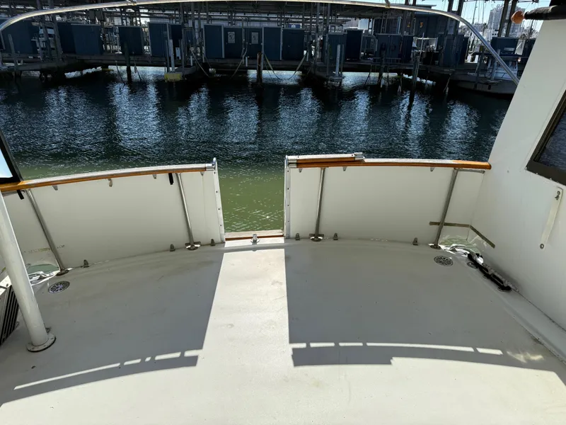 Slide: The Image of 1980 Hatteras 58MY yacht deck, docked at marina, calm water view. - 3