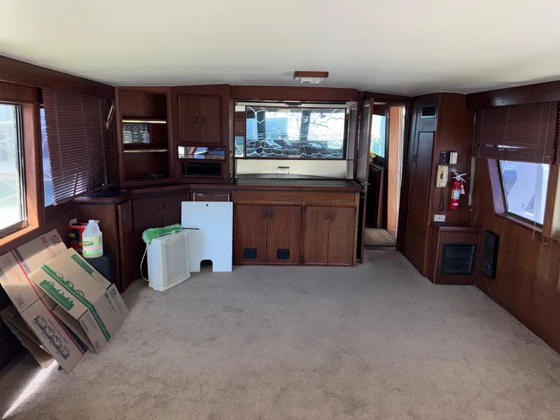 Slide: The Image of Interior of a 1980 Hatteras 58MY yacht with wood paneling and carpeted floor. - 5