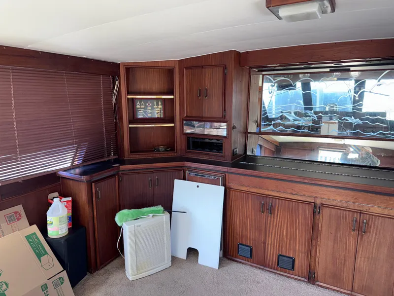 Slide: The Image of Interior of 1980 Hatteras 58MY yacht with wooden cabinetry and carpeted floor. - 6