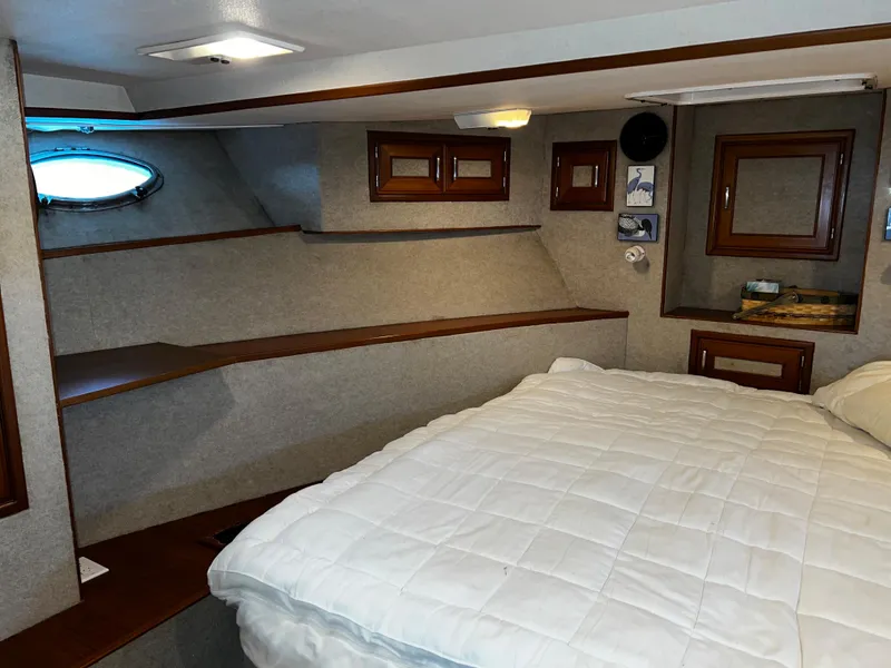 Slide: The Image of Cozy cabin interior of 1990 Nova 4500 boat with bed and wooden accents. - 14