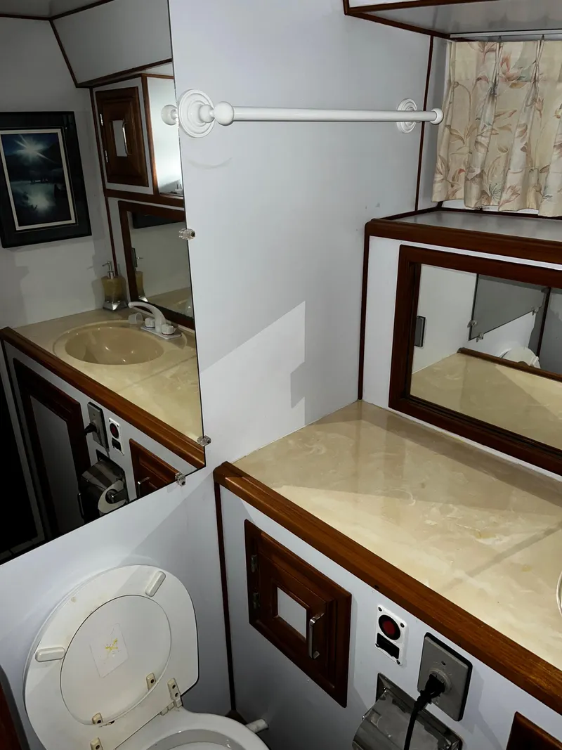 Slide: The Image of 1990 Nova 4500 bathroom interior with sink, mirror, and toilet. - 16