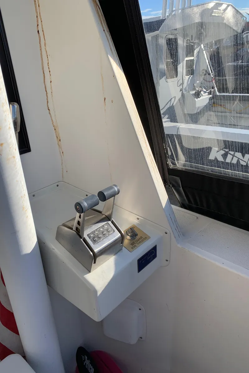 Slide: The Image of Control panel inside a 1990 Nova 4500 boat, featuring dual throttle levers. - 19