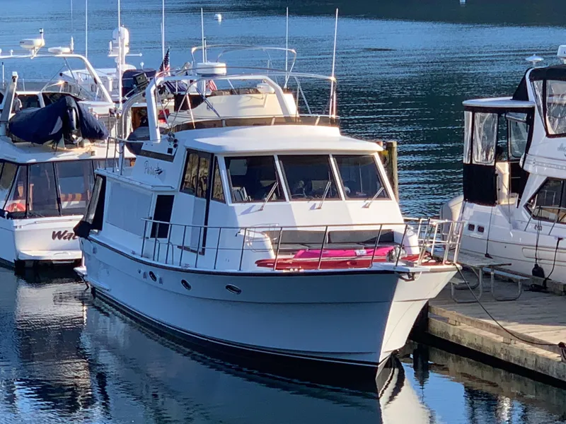Slide: The Image of A 1990 Nova 4500 yacht docked at a marina, surrounded by other boats. - 2