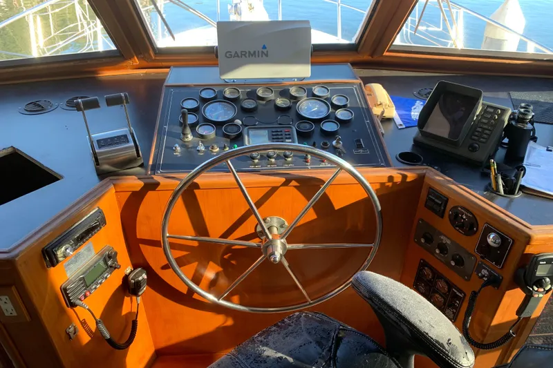 Slide: The Image of Cockpit of a 1990 Nova 4500 boat with steering wheel and navigation instruments. - 20