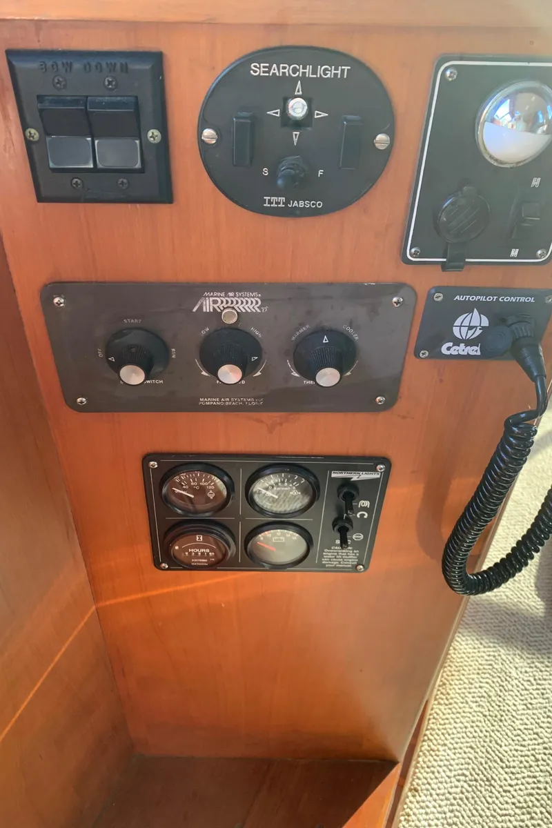 Slide: The Image of Control panel of a 1990 Nova 4500 boat with searchlight and communication equipment. - 24