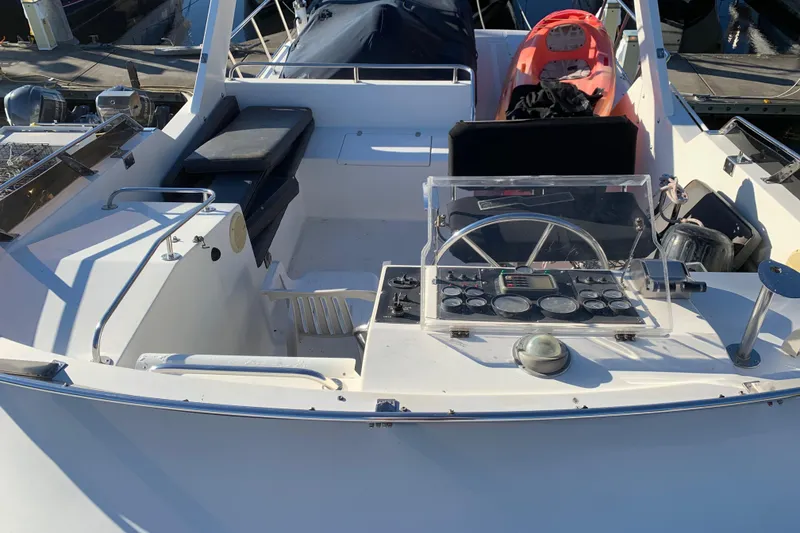 Slide: The Image of Cockpit of a 1990 Nova 4500 boat with steering wheel and control panel. - 27