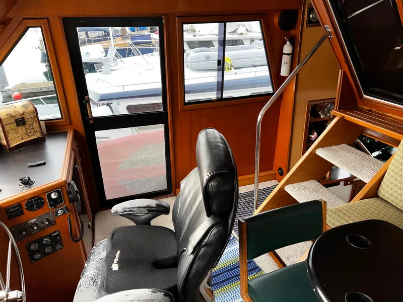Slide: The Image of Interior of a 1990 Nova 4500 boat with steering area and seating. - 4
